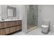Modern bathroom featuring a glass enclosed shower, vanity with sink, and contemporary toilet at 1020 Sunset Point Rd # 703, Clearwater, FL 33755