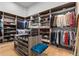 Spacious walk-in closet with custom shelving, drawers, and ample storage for shoes, clothes, and accessories at 1020 Sunset Point Rd # 703, Clearwater, FL 33755