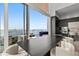 Dining area with a large table, comfortable chairs, and sliding doors leading to a balcony with water views at 1020 Sunset Point Rd # 703, Clearwater, FL 33755