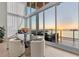 Dining area with floor-to-ceiling windows that provide beautiful sunset water views at 1020 Sunset Point Rd # 703, Clearwater, FL 33755