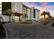 A modern building with lush landscaping and palm trees creates a tropical oasis at 1020 Sunset Point Rd # 703, Clearwater, FL 33755