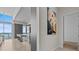 Hallway with a view of the kitchen and a contemporary art piece on the wall at 1020 Sunset Point Rd # 703, Clearwater, FL 33755