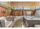 Relaxing outdoor area with a hot tub, swing chairs, and privacy fencing at 1020 Sunset Point Rd # 703, Clearwater, FL 33755