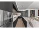 Open kitchen with double islands, marble counters, and stainless appliances, flowing into the living area at 1020 Sunset Point Rd # 703, Clearwater, FL 33755