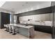 Modern kitchen featuring marble waterfall island, sleek cabinets, and stainless steel appliances at 1020 Sunset Point Rd # 703, Clearwater, FL 33755