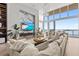 Bright and airy living room features a modern TV wall, water views, and stylish furnishings at 1020 Sunset Point Rd # 703, Clearwater, FL 33755