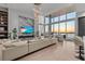 Bright living room showcases floor-to-ceiling windows, a waterfront view, and a stylish marble accent wall at 1020 Sunset Point Rd # 703, Clearwater, FL 33755