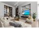 The living room boasts custom shelving, a chic bar area, and comfortable seating for entertaining guests at 1020 Sunset Point Rd # 703, Clearwater, FL 33755