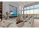 Waterfront living room with a modern TV wall, lots of comfy seating and panoramic views from every angle at 1020 Sunset Point Rd # 703, Clearwater, FL 33755