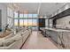 Open-concept living room with bar seating, a chef's kitchen, and expansive views of the water at 1020 Sunset Point Rd # 703, Clearwater, FL 33755