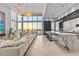 Spacious living room and kitchen with floor-to-ceiling windows and a stunning water view at 1020 Sunset Point Rd # 703, Clearwater, FL 33755