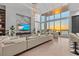 Bright living room with a water view, featuring a modern sectional sofa, built-in shelving, and unique lighting at 1020 Sunset Point Rd # 703, Clearwater, FL 33755