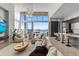 Spacious living room offers water views, an elegant chandelier, and comfortable seating arrangements at 1020 Sunset Point Rd # 703, Clearwater, FL 33755