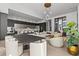 Expansive living room open to the kitchen, showcasing designer furnishings and an elegant bar area at 1020 Sunset Point Rd # 703, Clearwater, FL 33755