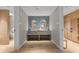 Upscale locker room area with double vanity, contemporary mirrors and wood lockers at 1020 Sunset Point Rd # 703, Clearwater, FL 33755