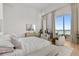 Spacious bedroom with floor-to-ceiling windows and comfortable furnishings at 1020 Sunset Point Rd # 703, Clearwater, FL 33755