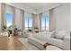 Bright bedroom with stunning water view, sitting area, and stylish furnishings at 1020 Sunset Point Rd # 703, Clearwater, FL 33755