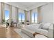 Bright bedroom with stunning water view, sitting area, and stylish furnishings at 1020 Sunset Point Rd # 703, Clearwater, FL 33755
