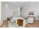 Bright bedroom with a comfortable sitting area and neutral decor at 1020 Sunset Point Rd # 703, Clearwater, FL 33755