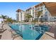 Take a dip in this inviting pool, surrounded by lush greenery and a sleek building design at 1020 Sunset Point Rd # 703, Clearwater, FL 33755
