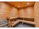 Classic wooden sauna with tiered benches and a traditional wood-burning stove at 1020 Sunset Point Rd # 703, Clearwater, FL 33755