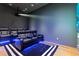 Home theater room with reclining leather seats, a projector, and a blue accent lighting for immersive experience at 1020 Sunset Point Rd # 703, Clearwater, FL 33755
