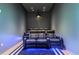Home theater room with reclining leather seats, a projector, and a blue accent lighting for immersive experience at 1020 Sunset Point Rd # 703, Clearwater, FL 33755