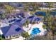 Aerial view of clubhouse and community pool surrounded by palm trees at 10214 Garden Alcove Dr, Tampa, FL 33647