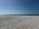 White sand beach view under a clear blue sky at 11730 Gulf Blvd # 5, Treasure Island, FL 33706