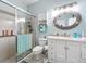 Bathroom features a glass-enclosed shower, single sink vanity, and nautical decorations at 1219 Huntington Greens Dr, Sun City Center, FL 33573