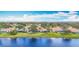 Picturesque single-story homes with waterfront views, enhanced by verdant lawns at 1219 Huntington Greens Dr, Sun City Center, FL 33573