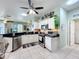 Kitchen featuring white cabinets, stainless steel appliances, and views of living room at 1219 Huntington Greens Dr, Sun City Center, FL 33573