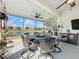 Enclosed lanai features an ornate metal table and chairs, ceiling fans, and a scenic lake view at 1219 Huntington Greens Dr, Sun City Center, FL 33573