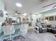 View of the kitchen that leads into the living room with a large gray sofa at 1219 Huntington Greens Dr, Sun City Center, FL 33573