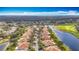 Aerial view of a beautiful community with lake and golf course at 1219 Huntington Greens Dr, Sun City Center, FL 33573