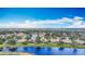 Aerial view showcasing a lakeside community with mature trees at 1219 Huntington Greens Dr, Sun City Center, FL 33573