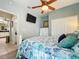 Bright bedroom with decorative bedspread, TV, and access to an ensuite bathroom at 1219 Huntington Greens Dr, Sun City Center, FL 33573