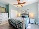 Inviting bedroom featuring a ceiling fan, a decorative bed frame, and neutral tones at 1219 Huntington Greens Dr, Sun City Center, FL 33573