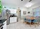Bright dining area features stainless steel appliances, white cabinets, and an adjacent stainless steel refrigerator at 1219 Huntington Greens Dr, Sun City Center, FL 33573