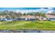 Back exterior of lakeside home featuring a screened lanai at 1219 Huntington Greens Dr, Sun City Center, FL 33573