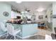 Modern kitchen featuring white cabinets, stainless steel appliances, an eat-in bar, and a dining area at 1219 Huntington Greens Dr, Sun City Center, FL 33573
