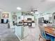 Bright kitchen featuring white cabinets, stainless steel appliances, an eat-in bar, and an open layout at 1219 Huntington Greens Dr, Sun City Center, FL 33573