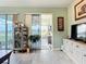 Bright and airy living room with views of a nearby pond, sliding glass doors to a screened patio, and neutral decor at 1219 Huntington Greens Dr, Sun City Center, FL 33573