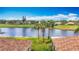 Rooftop view of a pond and manicured lawn behind a community at 1219 Huntington Greens Dr, Sun City Center, FL 33573
