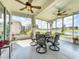 Enjoy serene water views from this screened-in porch with an outdoor dining area at 1219 Huntington Greens Dr, Sun City Center, FL 33573