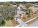 Aerial view of a well-maintained home with lush landscaping and a spacious driveway at 12503 Willow Tree Ave, Hudson, FL 34669