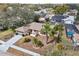 Aerial view of a well-maintained home with lush landscaping and a spacious driveway at 12503 Willow Tree Ave, Hudson, FL 34669