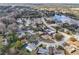 A beautiful aerial view of a suburban neighborhood next to a large lake at 12503 Willow Tree Ave, Hudson, FL 34669