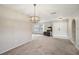 Bright living room featuring neutral walls and flooring with double door entry at 12503 Willow Tree Ave, Hudson, FL 34669
