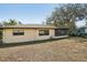 View of the back of the house, showcasing a cozy enclosed porch at 12503 Willow Tree Ave, Hudson, FL 34669